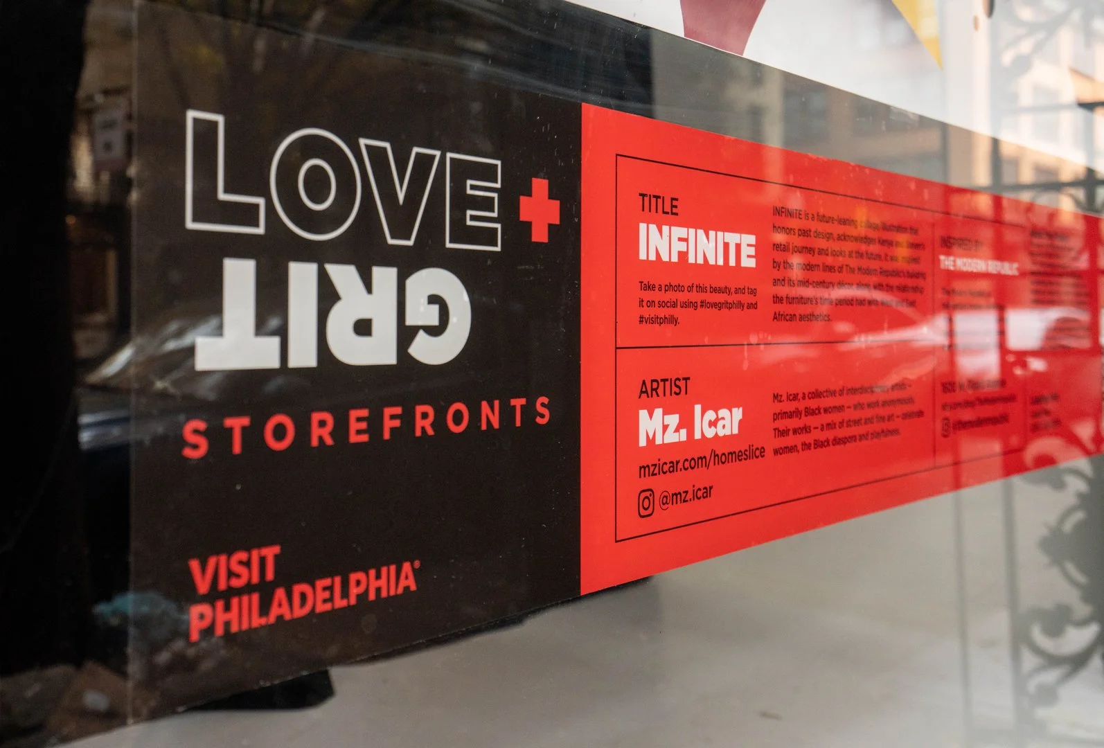 Love + Grit artwork installed across a storefront