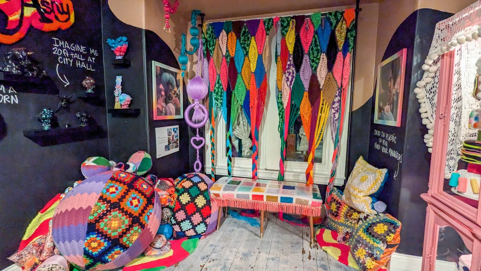 Colorful textile installation and seating in the gallery