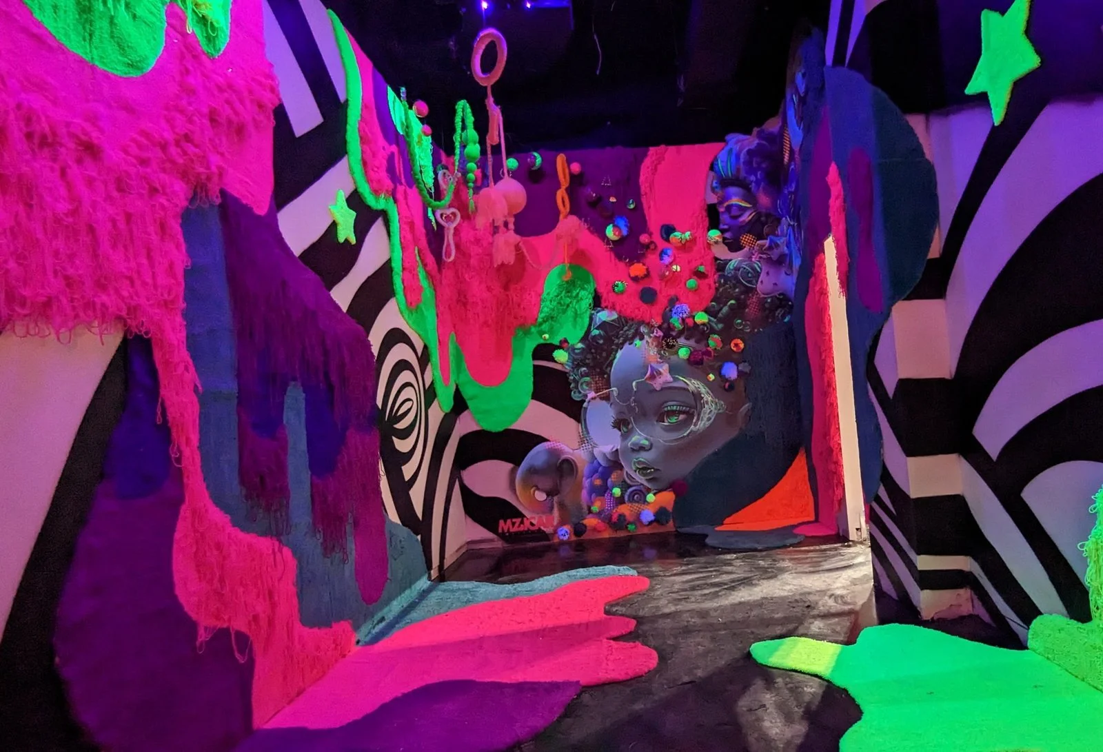 Tufted installation under colored lighting at Otherworld